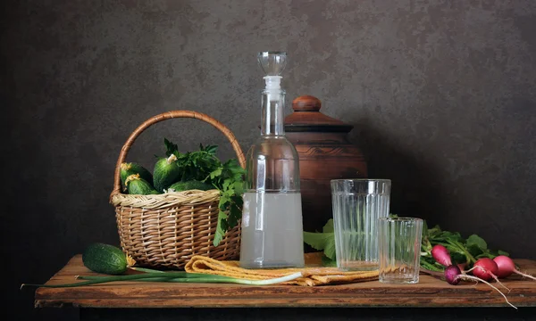 Still life with moonshine, radish and fresh cucumbers. — Stock Photo, Image