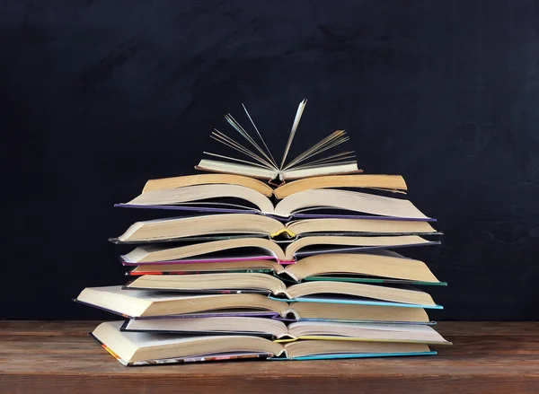 Stack of open books, school blackboard. Back to school. — Stock Photo, Image