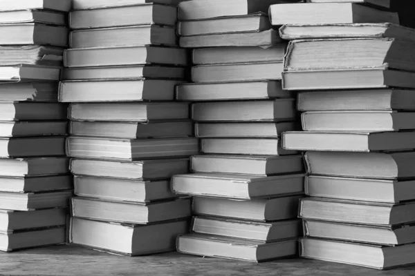 Background from books. The piles of books on the shelf closeup. Library. Back to school. monochrome.