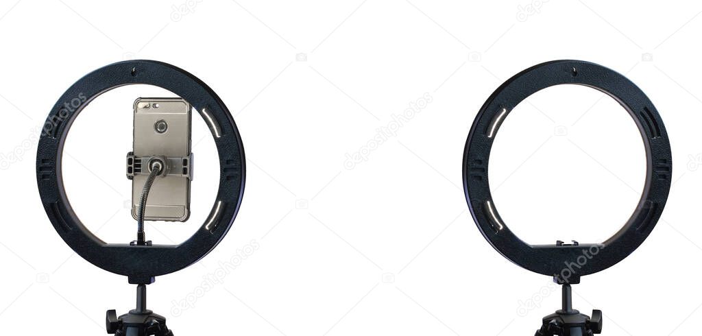 ring lamp and a smartphone on a tripod isolated on a white background with a clipping path.  inexpensive photo equipment.