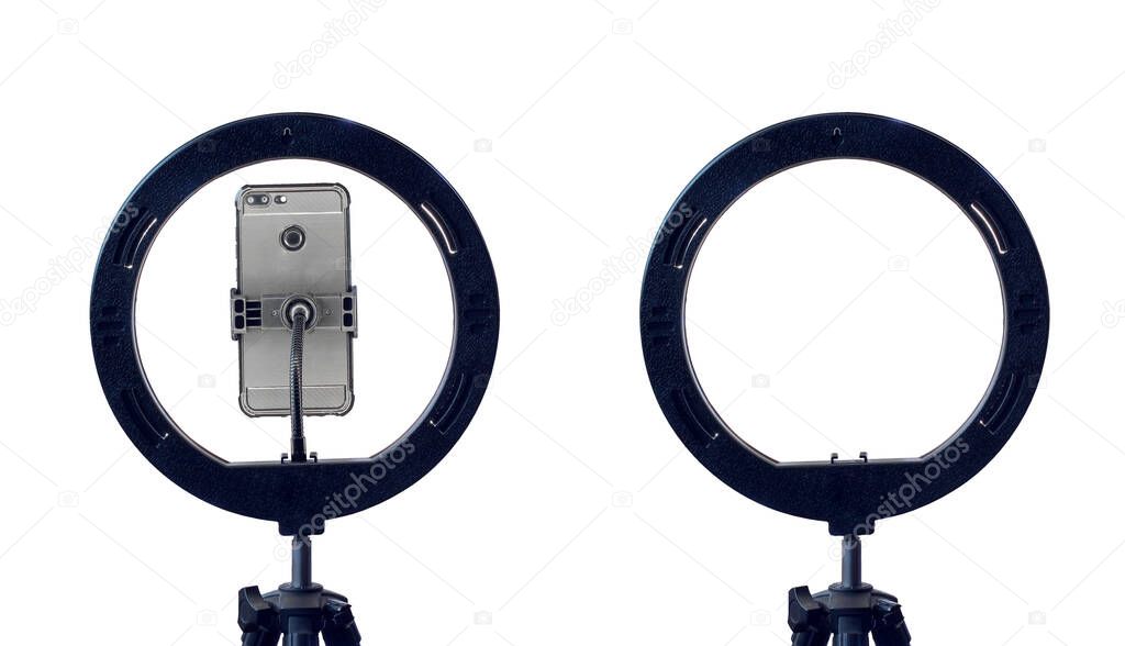 ring lamp and a smartphone on a tripod, isolated on a white background with a clipping path. inexpensive equipment for home video or photo shooting.
