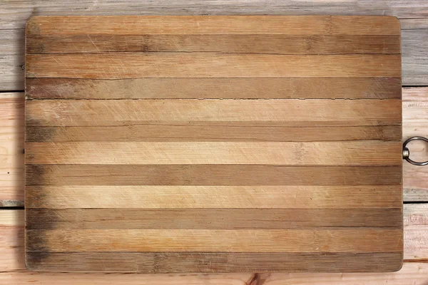 Chopping board in a strip on a wooden table