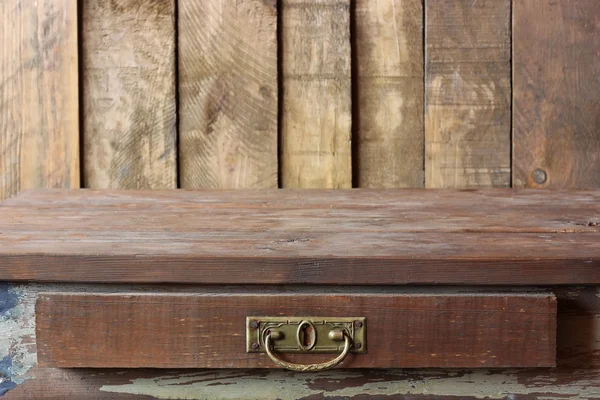 Empty wooden table against a wall from boards. — Stock Photo, Image