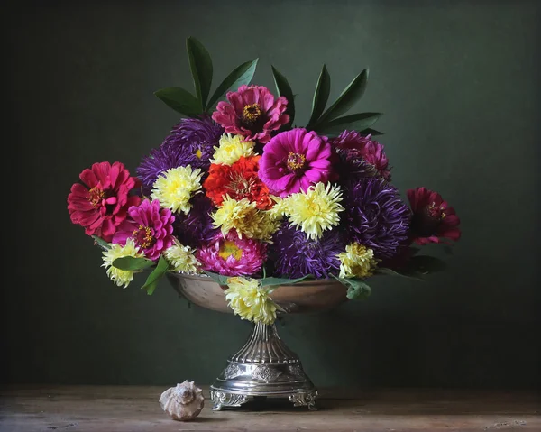 Autumn flowers in an iron vase — Stock Photo, Image