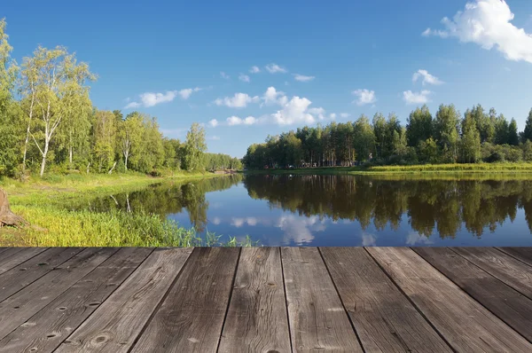Деревянный пол террасы у озера — стоковое фото
