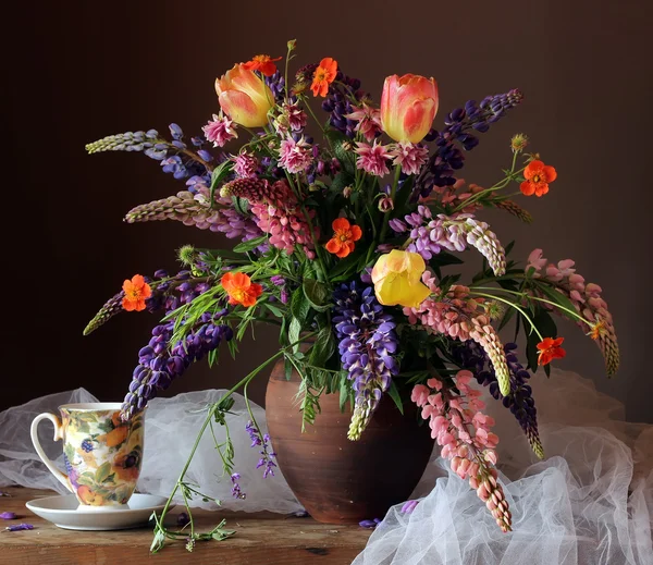 Still life with a bouquet of lupines. — Stock Photo, Image