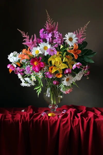 Bouquet from cultivated flowers in a jug. — Stock Photo, Image