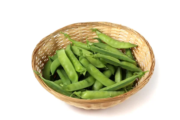 The pods of green peas in a basket isolated on a white background. — Stock Photo, Image