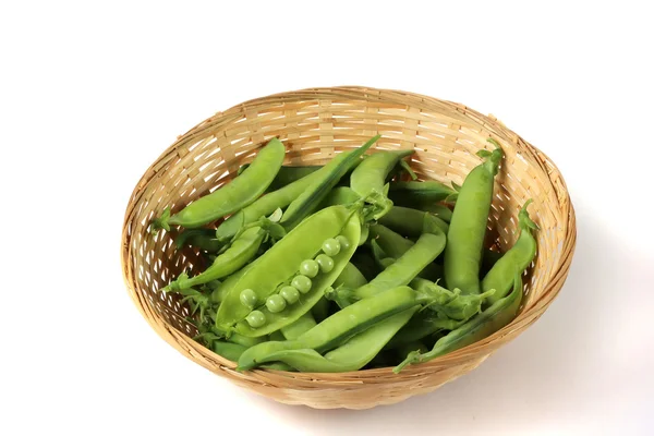 The pods of green peas in a basket isolated on a white background. — Stock Photo, Image