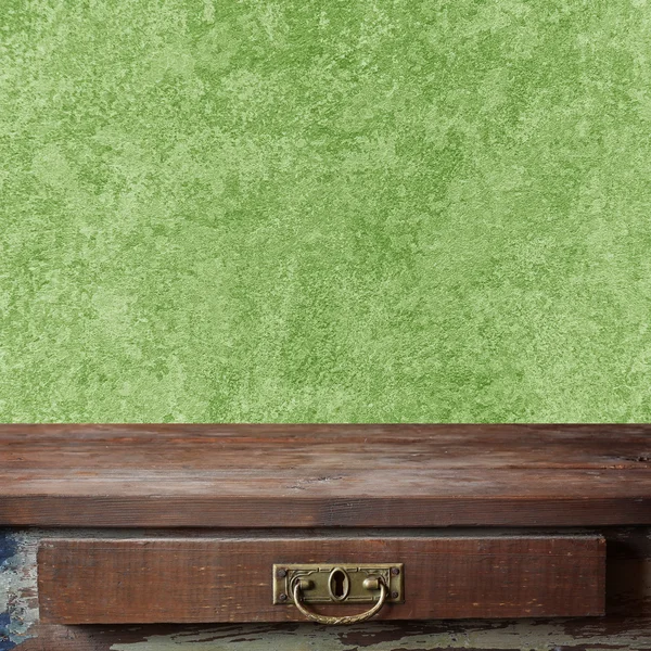 Empty wooden table against a green wall. — Stock Photo, Image