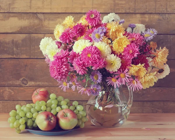 Nature morte avec un bouquet et des fruits. Chrysanthèmes . — Photo