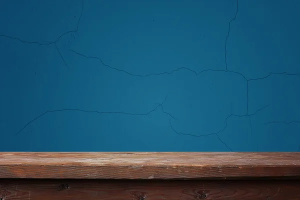 Boş ahşap masa mavi bir duvara karşı — Stok fotoğraf