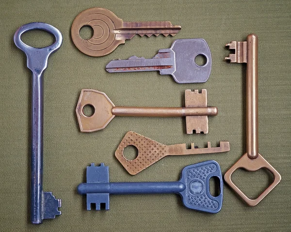 Seven keys on a green background. — Stock Photo, Image