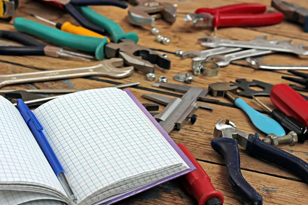 The book for records and tools on a timber floor. — Stock Photo, Image