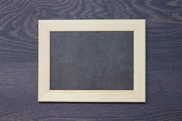 Wooden frame for photos against a dark background. — Stock Photo, Image