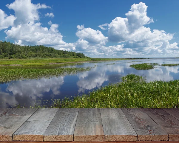 Empty wooden flooring against the summer river. — Stock Photo, Image