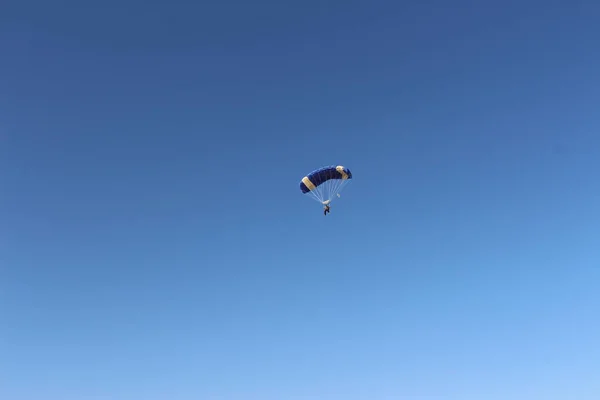 Person falling from the sky by parachute