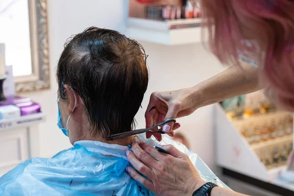Hairdresser cutting a man's hair