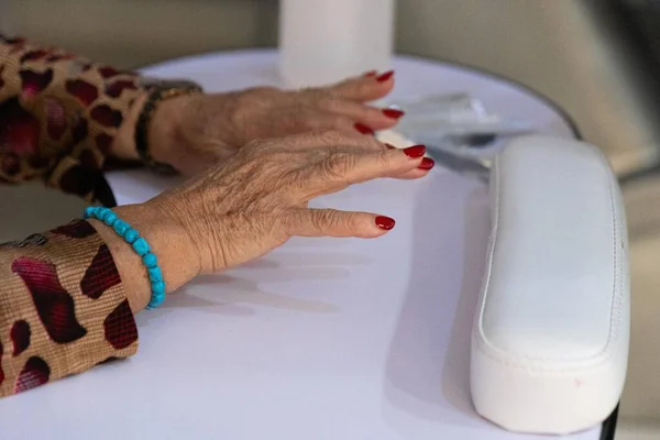 Hands of an older woman getting a manicure