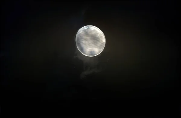 Illustration of night sky with moon and dark stormy clouds