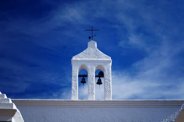 Small old white bell tower of the local chapel. Located in Los Reartes, Cordoba