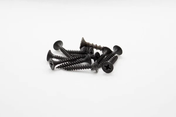 Close View Bunch Black Screws White Surface — Zdjęcie stockowe