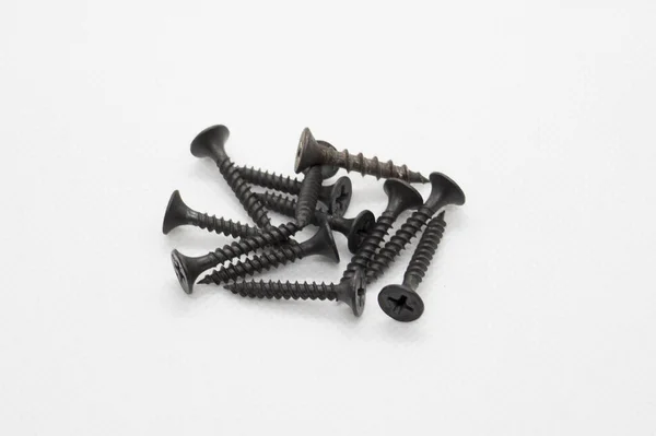 Close View Bunch Black Screws White Surface — Zdjęcie stockowe