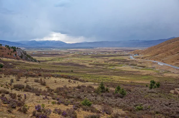 Mavi kümülüs yağmurlu bulutlar engin kahverengi vadinin üzerinde