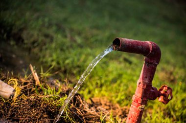 Su israfı. Çelik bir borudan taze su akıyor..