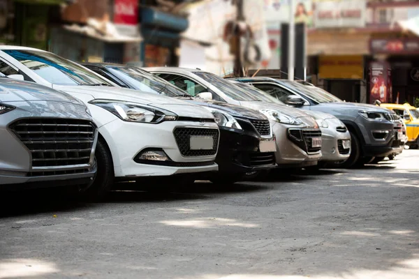 stock image Front view of the of cars parked in a row beside road in city Parking lot