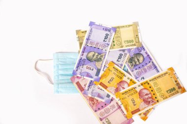 Indian rupee and protective face masks isolated on white background.