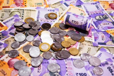arka plan olarak çeşitli Hint kağıt para birimi banknotları ve sikkeleri