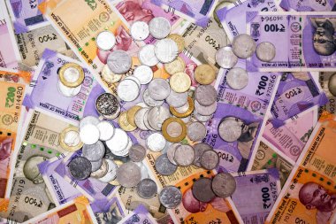 arka plan olarak çeşitli Hint kağıt para birimi banknotları ve sikkeleri