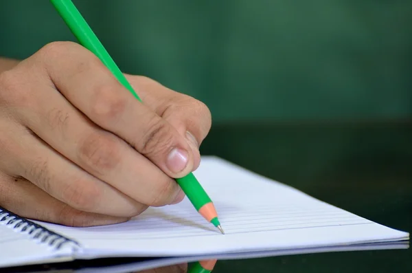 Human hand writing on a notepad — Stock Photo, Image