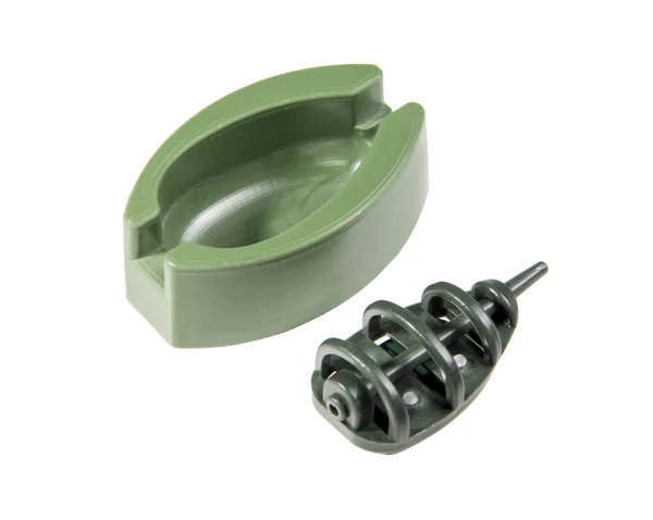 Green plastic molding with a fishing feeder — Stock Photo, Image