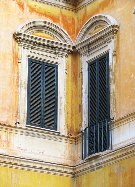 Diptych of Rome windows in orange house, renaissance windows with closed jalousies