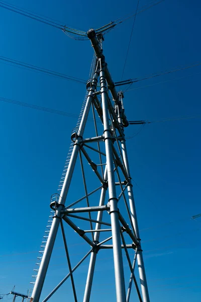 Large massive metal electric pole on four supports. — Stock Photo, Image