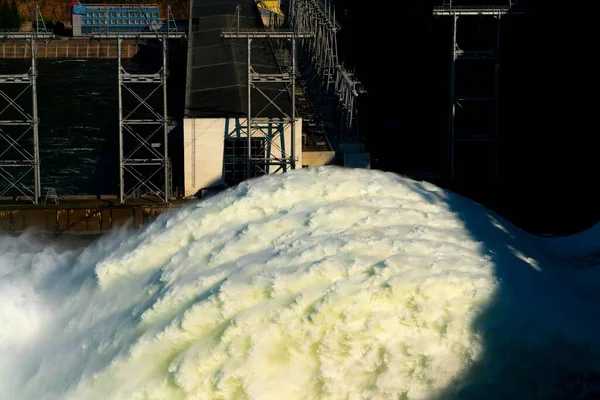 Eine lange Wasserfahne, die aus einem Wasserkraftwerk abgelassen wird. — Stockfoto