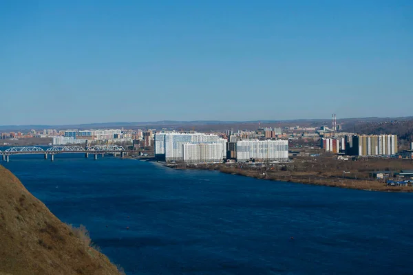 Panorama of an industrial city on the opposite side of the river.