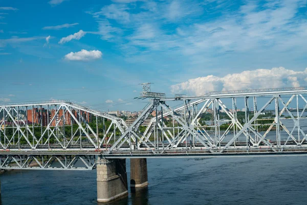 Αψίδα σιδηροδρομικής γέφυρας πάνω από ποτάμι σε βιομηχανική πόλη. — Φωτογραφία Αρχείου