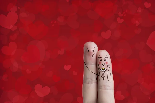 L'arte delle dita di una coppia felice. Immagine stock. L'uomo abbraccia e dona fiori . — Foto Stock