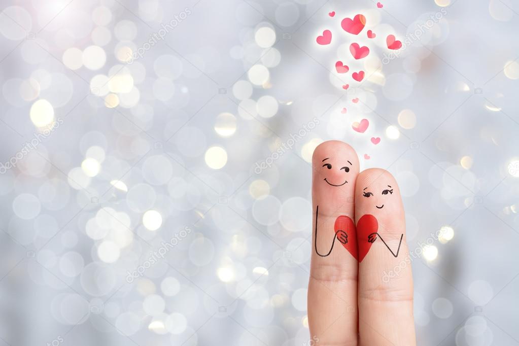 Finger art of a Happy couple. Lovers is embracing and holding red heart. Stock Image