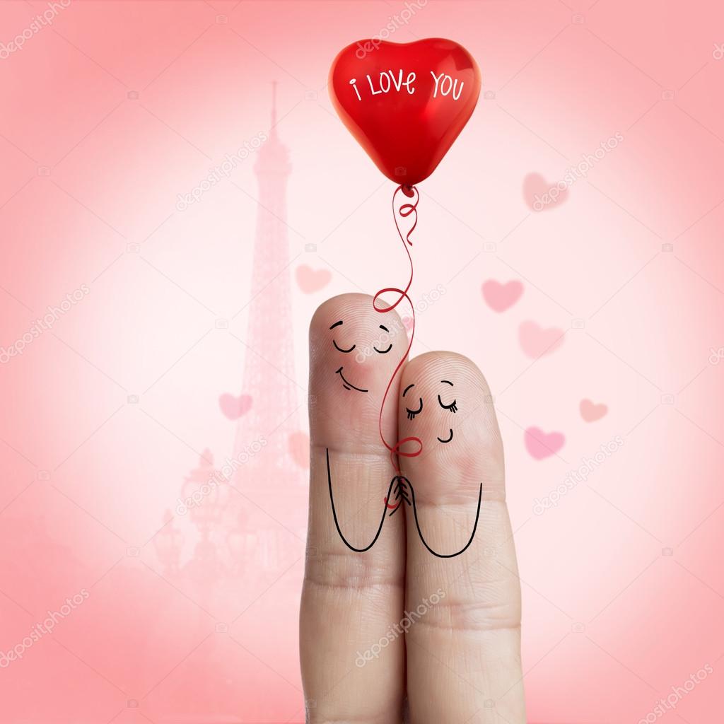 Finger art of a Happy couple. Lovers is embracing and holding red balloon against the background оf  the Eiffel tower. Stock Image