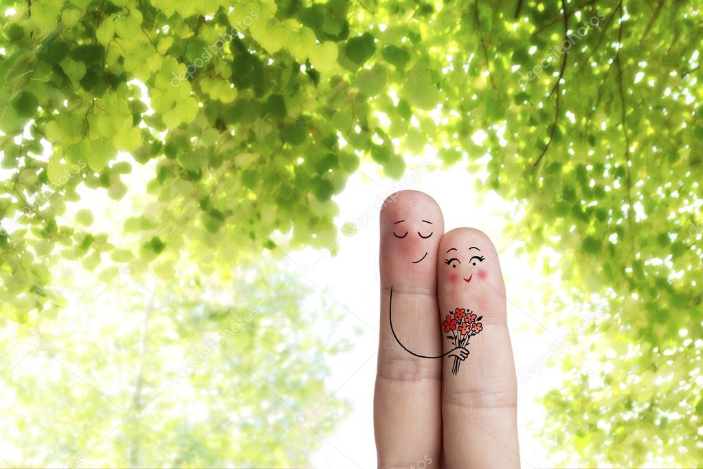 Finger art. Lovers is embracing and holding bouquet. Creative Stock Image
