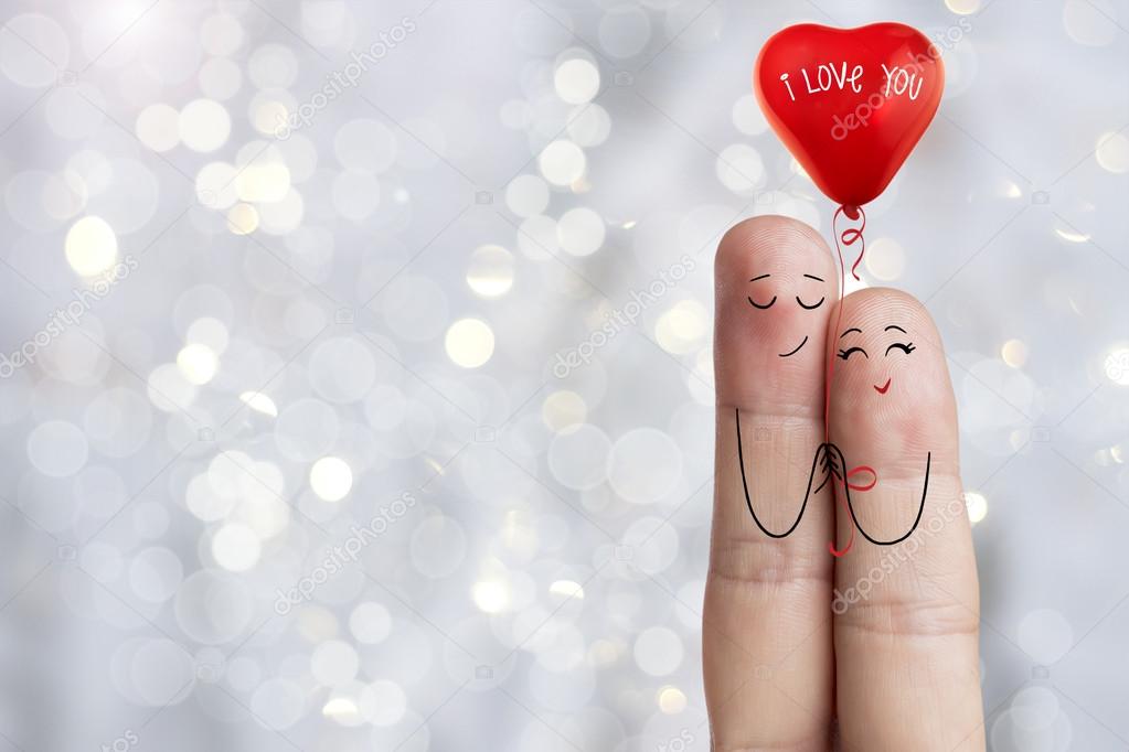 Finger art. Lovers is embracing and holding  red balloon. Stock Image