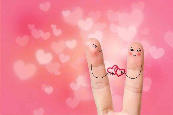 Conceptual finger art. Lovers are embracing and holding hearts. Stock Image — Stock Photo, Image