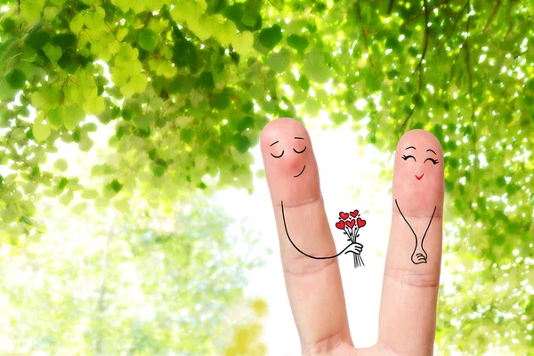 Conceptual finger art. Lovers are embracing and giving bouquet. Stock Image — Stock Photo, Image