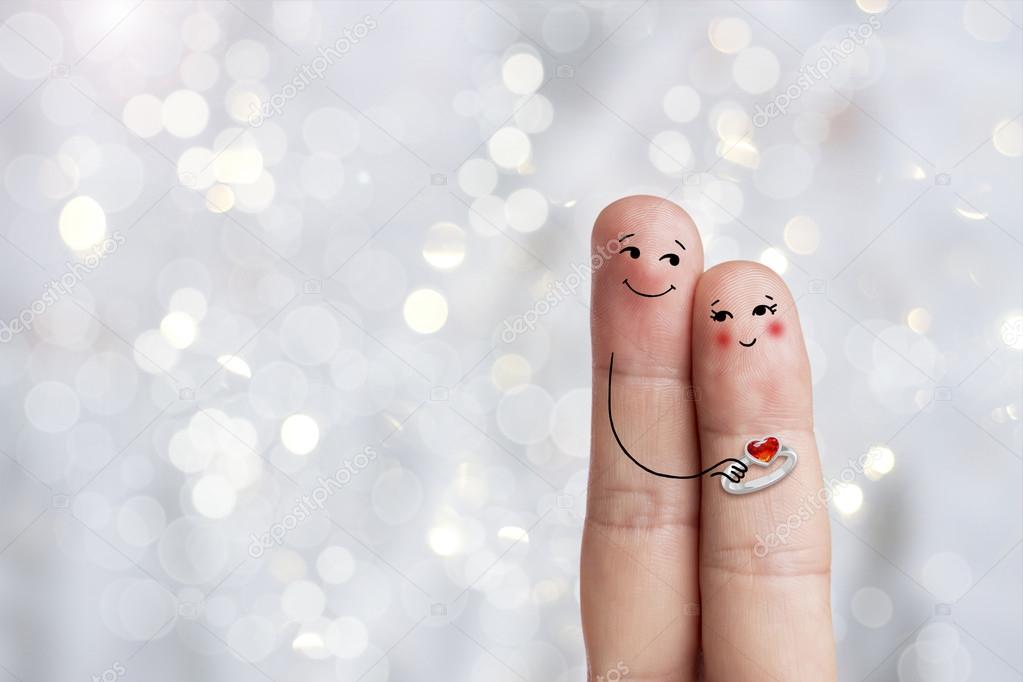 Conceptual finger art of a Happy couple. Man is giving a ring. Stock Image