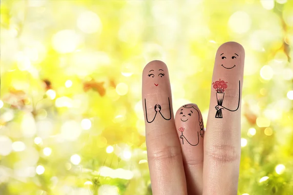 Conceptual family finger art. Father and daughter  are giving flowers to their mother — Stock Photo, Image