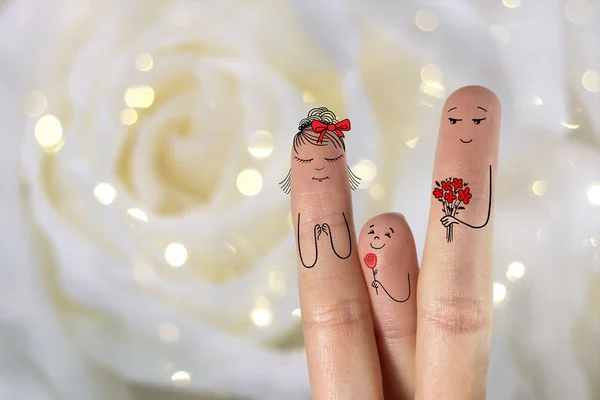 Conceptual family finger art. Father and son are giving flowers  his mother. Stock Image — Stock Photo, Image